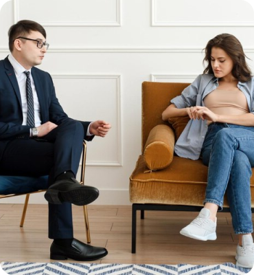 A couple receiving divorce counseling while sitting on a couch.
