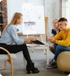 A group receiving divorce counseling sitting around a table in an office.