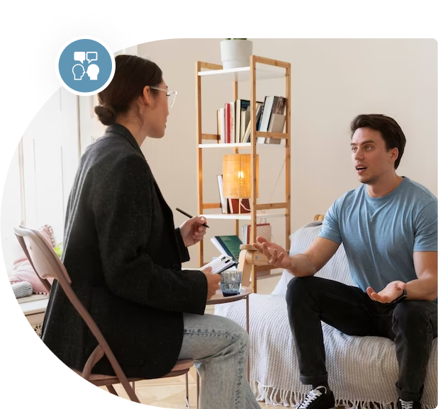 A Registered Clinical Counsellor providing therapy to a woman in a bedroom.