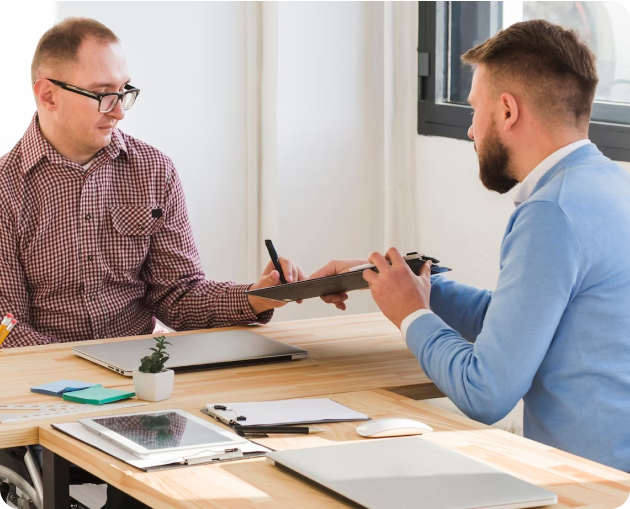 Two men engaging in divorce counseling at a desk.