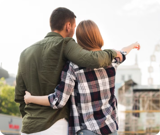 A couple embracing in front of a ferris wheel portrays intimacy in the context of couples and family therapy.