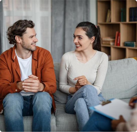 A couple engaging in Couples Therapy with a therapist.