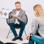 A Surrey counselor converses with a woman in a chair.