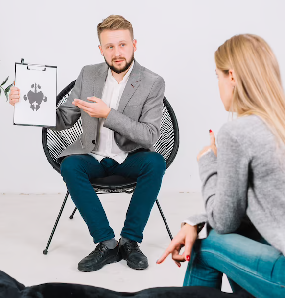 A Surrey counselor converses with a woman in a chair.