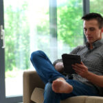 A man using a tablet computer for mental health.