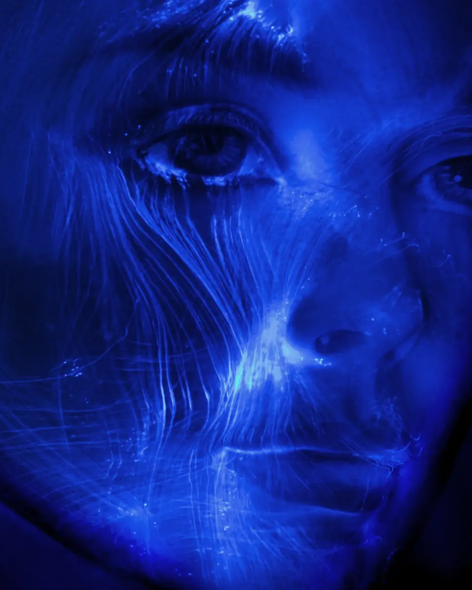 Blue double-exposure portrait representing the internal conflict of addiction